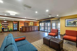a living room with a couch and two chairs at Comfort Suites McKinney-Allen in McKinney