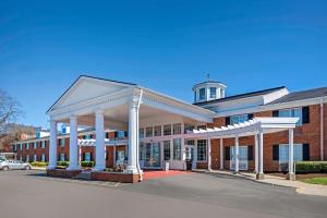 a large brick building with a clock tower on top at Clarion Hotel Conference Center Lexington North in Lexington