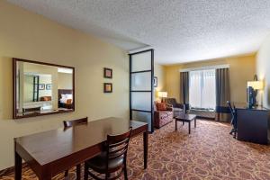 a living room with a dining room table and chairs at Comfort Suites McKinney-Allen in McKinney