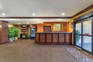 a hotel lobby with a bar in the middle at Comfort Suites McKinney-Allen in McKinney