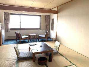 
a living room filled with furniture and a window at Toya Kanko Hotel in Lake Toya

