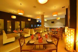 a dining room with tables and chairs and a restaurant at SRM Hotel in Tuticorin