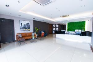 a living room with a couch and a table at Hotel 99 Bandar Puteri Puchong in Puchong