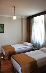 Postel nebo postele na pokoji v ubytování Saban Acikgoz Hotel + 14 fotografií