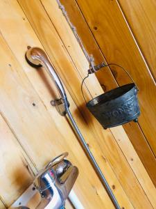 a bucket is hanging on a wooden wall at Dream Tricule in Sviniţa