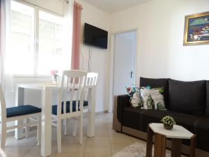 a living room with a couch and a table at Apartman Zorana in Bar