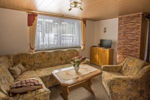 a living room with a couch and a coffee table at Ferienhaus Gläser in Bockau