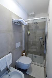 a bathroom with a shower and a toilet and a sink at Timpa b&b in Pizzo