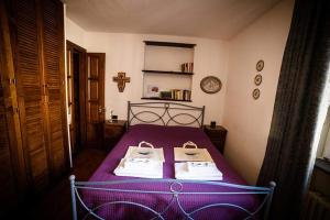 
a bedroom with a bed and a dresser at Camere Nicolina in Vernazza
