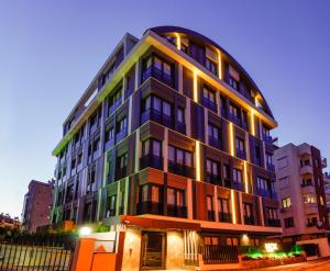 a tall building with lights on the side of it at Nox Suite Rezidans in Antalya