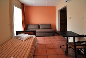 a living room with a couch and a table at Golden View in Poros