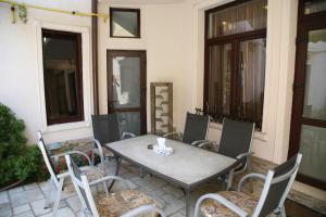 a table and chairs sitting on a patio at City Garden Rooms and Apartments in Bucharest