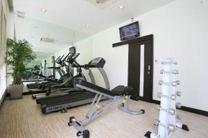 a gym with a row of tread machines in a room at FX Hotel Metrolink Makkasan in Bangkok