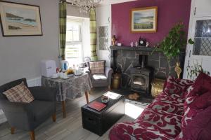 a living room with a couch and a fireplace at Kings Accommodation in Donegal