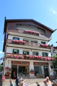 a large building with a sign on the side of it at Hotel Montana- ricarica auto elettriche in Cortina dʼAmpezzo