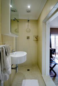 a bathroom with a sink and a shower at Villa Costa Rose - No Loadshedding in Cape Town