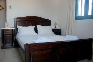 a bedroom with a bed with two towels on it at Eleni Apts in Kamilari