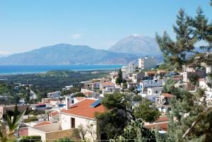 a view of a city and the water at Eleni Apts in Kamilari