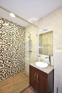 a bathroom with a sink and a shower at Luxury apartments just near Republic Square in Yerevan