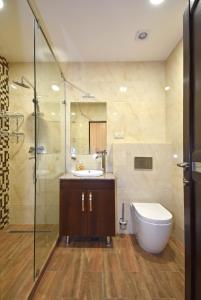 a bathroom with a toilet and a sink and a shower at Luxury apartments just near Republic Square in Yerevan
