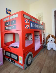 a red double decker bus bunk bed in a room at The Winter Garden Suites in Blackpool