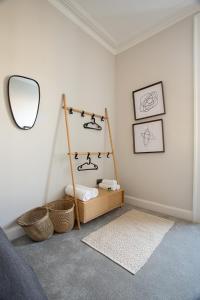 a bedroom with a mirror and a shelf with baskets at Holyrood Park City Centre Apartment in Edinburgh