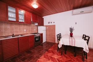 a kitchen with a table with a table cloth at Apartments & Rooms Peranic in Novalja