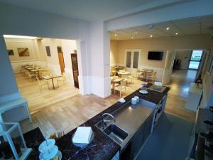 a view of a kitchen and a living room at Hotel Milani in Lido di Camaiore