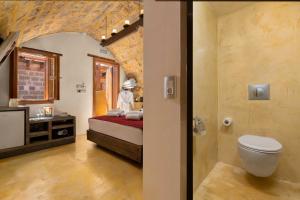 a bathroom with a bed and a sink and a toilet at 10GR Boutique Hotel & Wine Bar in Rhodes Town