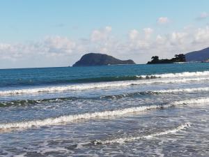 a beach with small waves in the ocean at Villa Daizy Boutique Apartments in Laganas