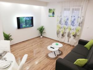 a living room with a couch and a table at Apartments MTV - private parking, Fast Wi-Fi & Steps to the Beach in Zadar
