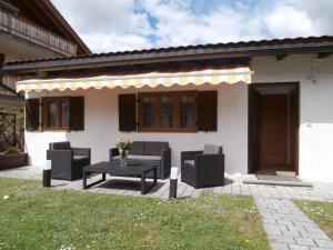 a patio with chairs and a table in front of a house at Ferienwohnung Anna in Garmisch-Partenkirchen