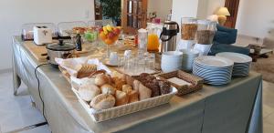 a table with a buffet with bread and other foods at Quinta Nova Vale Del Rey in Carvoeiro