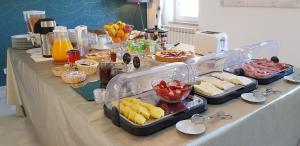 a table topped with trays of food on a table at Quinta Nova Vale Del Rey in Carvoeiro