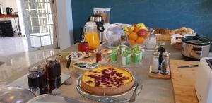 a table with a cake and fruits on a counter at Quinta Nova Vale Del Rey in Carvoeiro
