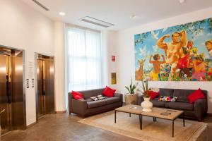 a living room with two couches and a painting on the wall at Hotel Portavaldera in Peccioli