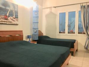 a bedroom with two beds and a window at I Sentieri in Rio nellʼElba