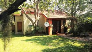 a house with a clock on the front of it at Raka Cottage - No loadshedding in Nelspruit