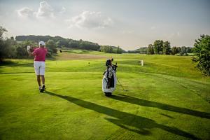 a man is playing golf on a golf course at Pannónia Golf & Country Club in Alcsútdoboz