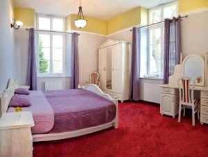 a bedroom with a bed and a red carpet at Pałac w Krzelowie in Krzelów