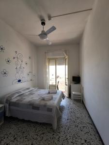 a bedroom with a large bed and a window at Hotel Milani in Lido di Camaiore