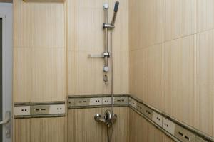 a shower in a bathroom with wooden walls at Studio Treti Mart South in Primorsko +39 photos