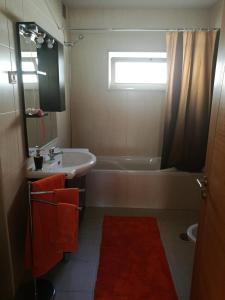 a bathroom with a sink and a bath tub at Casa Carla in Guimarães