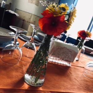 un vaso con dei fiori, seduto su un tavolo. di B&B Terre dì Montecoco a San Pancrazio Salentino