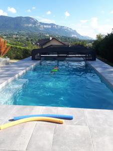 a person swimming in a swimming pool at Le Plein Soleil in Grésy-sur-Aix