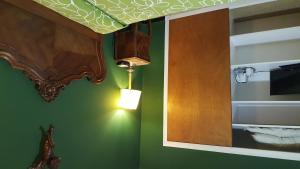 a bathroom with a mirror and a light on the wall at Hostal Residencia Catalina in Palamós