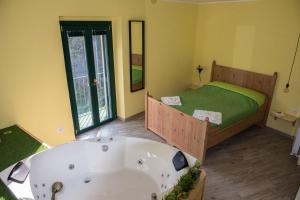 baño con bañera y cama en Helvetia Bed & Breakfast, en Castelmezzano