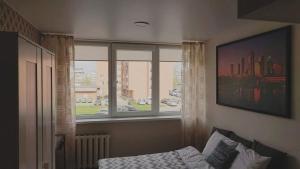 a bedroom with a window and a bed in front at Studija29 in Klaipėda