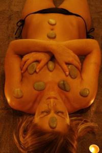 a woman laying on her back with buttons on her face at Hotel Fior Di Bosco in Giovo