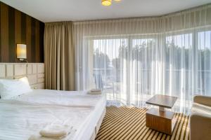 Postel nebo postele na pokoji v ubytování Hotel White
